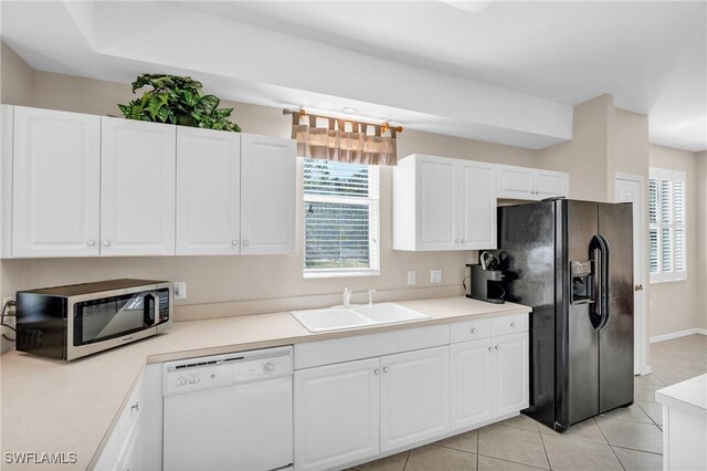 3970 Loblolly Bay Dr Unit 5-108, Naples, FL 34114 - kitchen featuring white dishwasher, a sink, black fridge with ice dispenser, white cabinets, and plenty of natural light