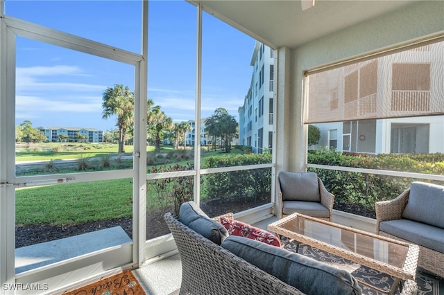 sunroom / solarium with a water view