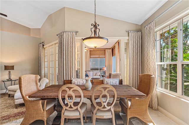 tiled dining space with vaulted ceiling