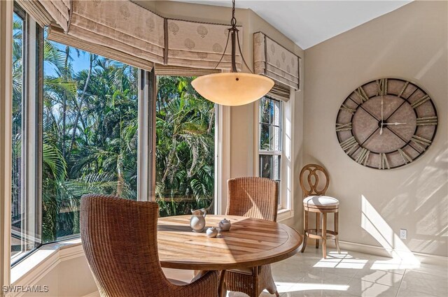 dining space featuring light tile patterned floors