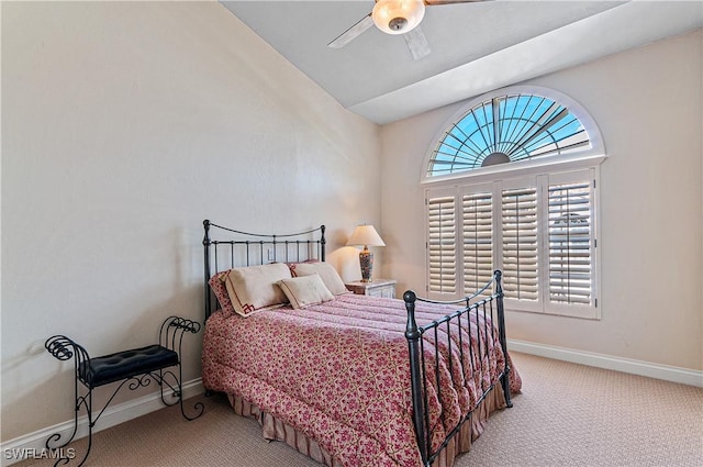 carpeted bedroom with ceiling fan, multiple windows, and baseboards