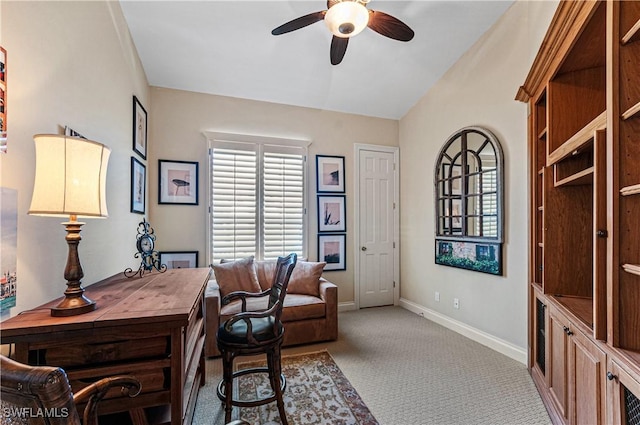 office space with vaulted ceiling, carpet flooring, ceiling fan, and baseboards