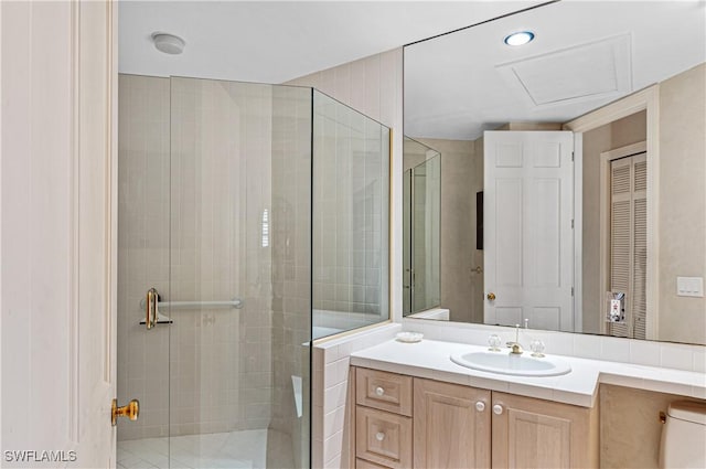 full bathroom featuring toilet, a shower stall, and vanity