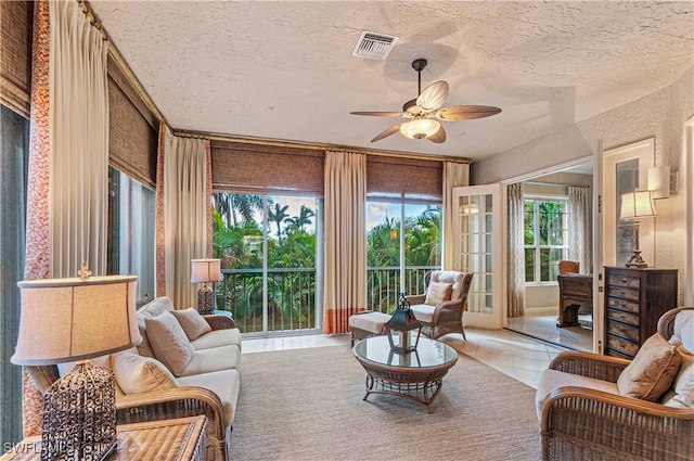 sunroom / solarium featuring visible vents and a ceiling fan