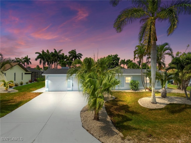 view of front facade with a yard and a garage