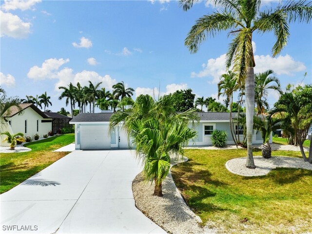 ranch-style house featuring a garage and a front yard