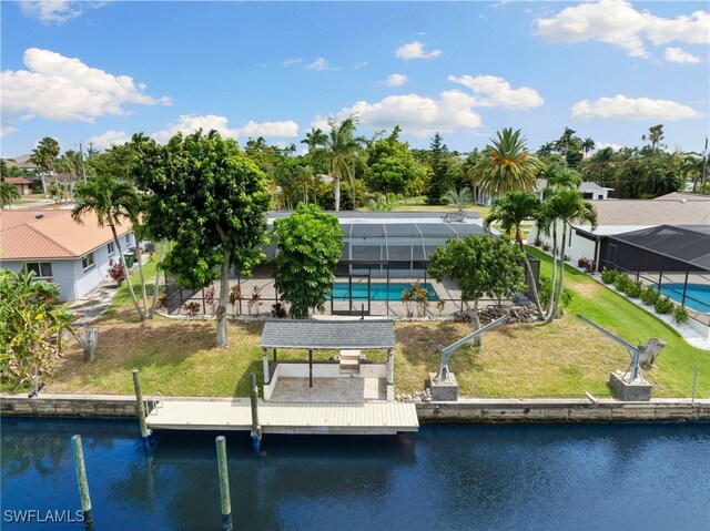 dock area featuring a patio, a yard, glass enclosure, and a water view