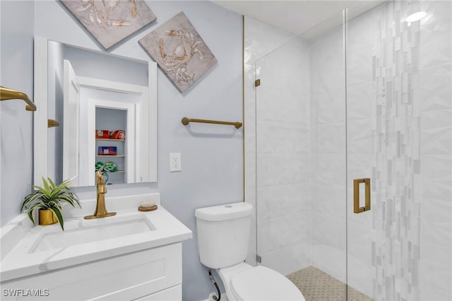 bathroom with vanity, a shower with shower door, and toilet