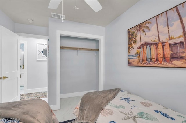 bedroom featuring ceiling fan and a closet