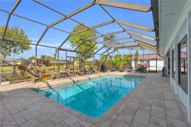 view of pool with a lanai and a patio