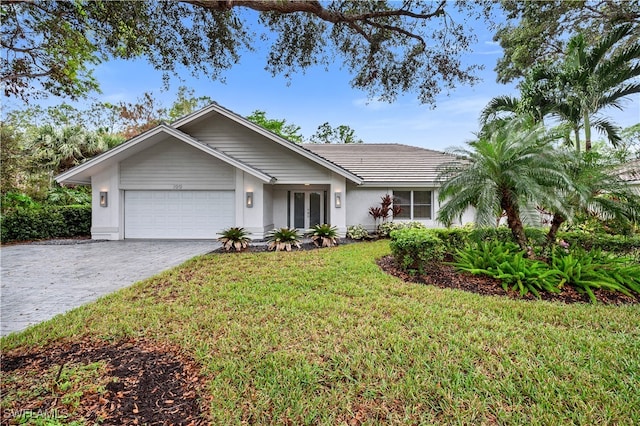 ranch-style house featuring a garage and a front lawn