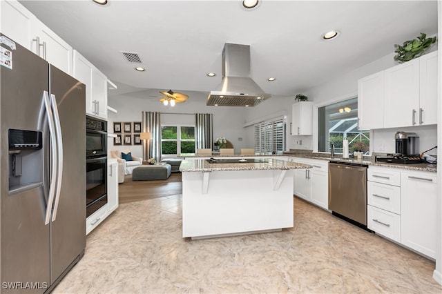 kitchen with white cabinets, a healthy amount of sunlight, island range hood, and appliances with stainless steel finishes