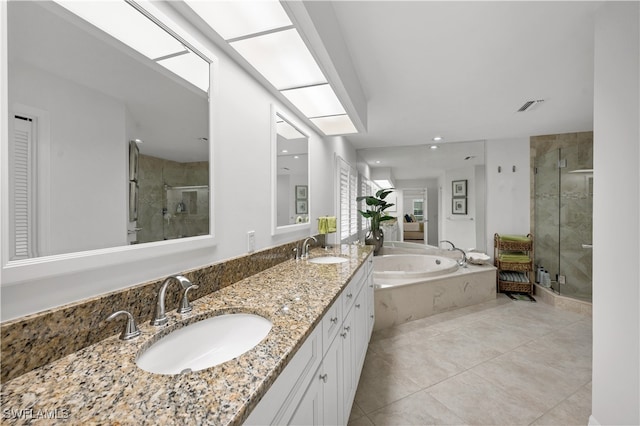 bathroom featuring vanity, plus walk in shower, and tile patterned floors