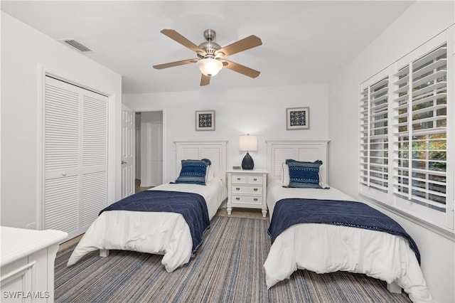 bedroom with ceiling fan and a closet