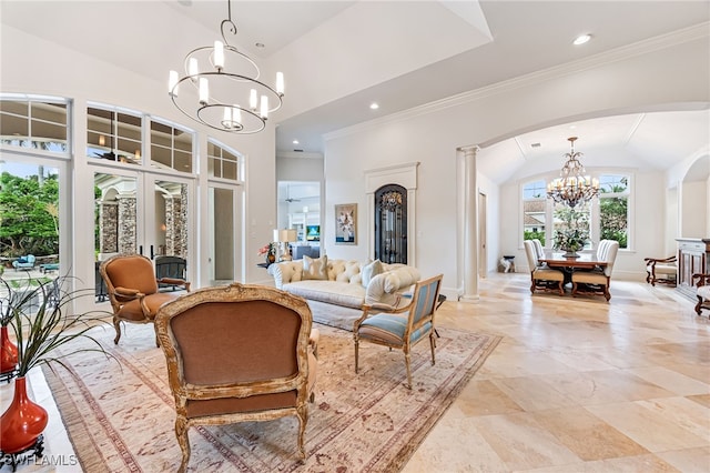 living room with a chandelier, lofted ceiling, french doors, and decorative columns