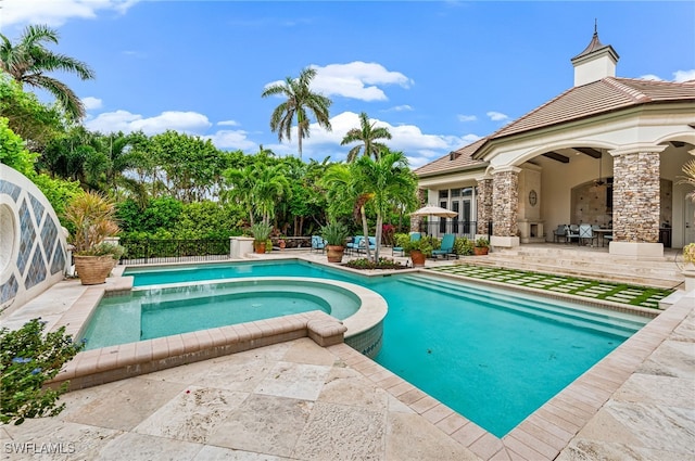 view of pool with an in ground hot tub and a patio