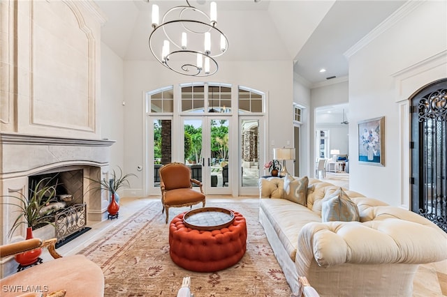 living room featuring french doors, a high end fireplace, high vaulted ceiling, a notable chandelier, and crown molding