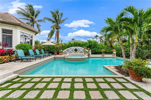 view of pool with a patio area and an in ground hot tub