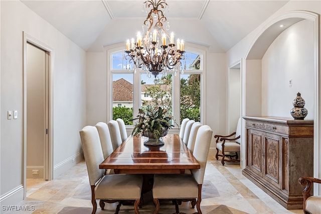 dining room featuring vaulted ceiling and a notable chandelier