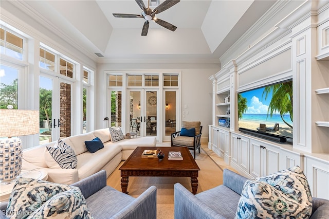 living room featuring french doors, a raised ceiling, and crown molding