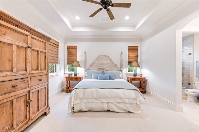 bedroom with light carpet, ensuite bathroom, ceiling fan, and crown molding