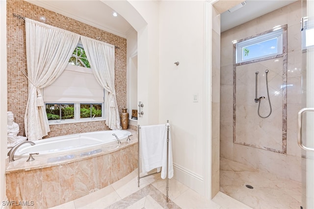 bathroom featuring separate shower and tub and a healthy amount of sunlight