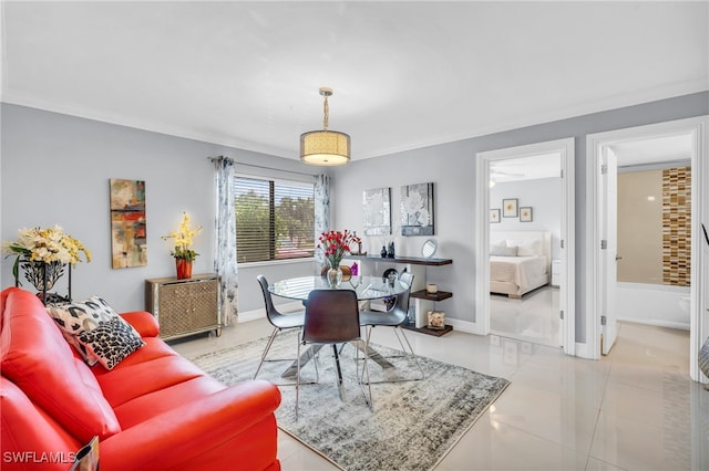 dining area featuring light tile patterned floors and crown molding