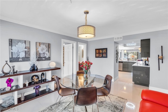 dining space featuring light tile patterned floors and crown molding