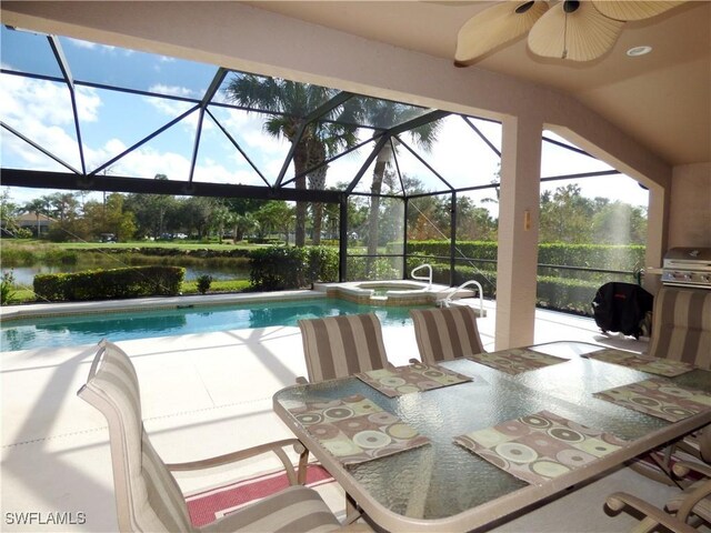 view of swimming pool featuring an in ground hot tub, ceiling fan, a water view, glass enclosure, and a patio