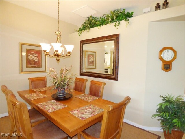 dining area featuring a chandelier and carpet flooring