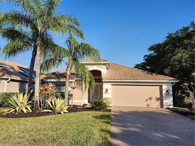 view of front of house featuring a garage and a front lawn