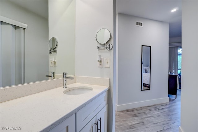 bathroom with hardwood / wood-style flooring and vanity