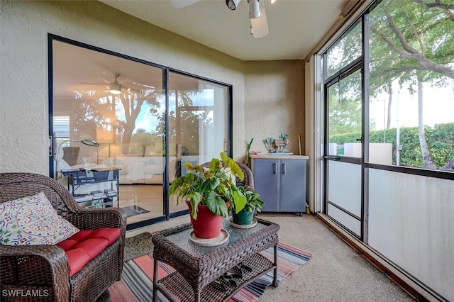 sunroom featuring ceiling fan