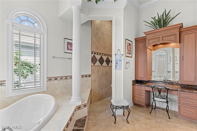 bathroom with tile patterned flooring, a relaxing tiled tub, vanity, crown molding, and decorative columns