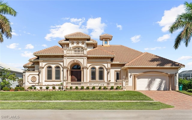 mediterranean / spanish house with a garage and a front yard