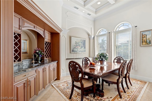 tiled dining room featuring a high ceiling, sink, ornamental molding, beam ceiling, and coffered ceiling