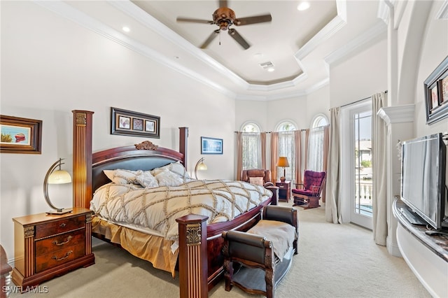 carpeted bedroom with ornamental molding, ceiling fan, a towering ceiling, a raised ceiling, and access to outside