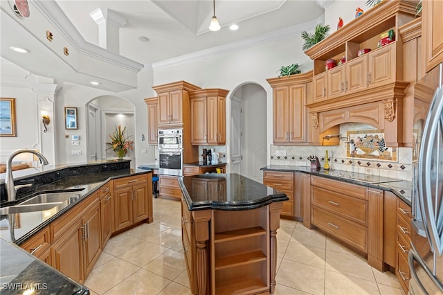 kitchen with stainless steel appliances, sink, light tile patterned floors, and a center island