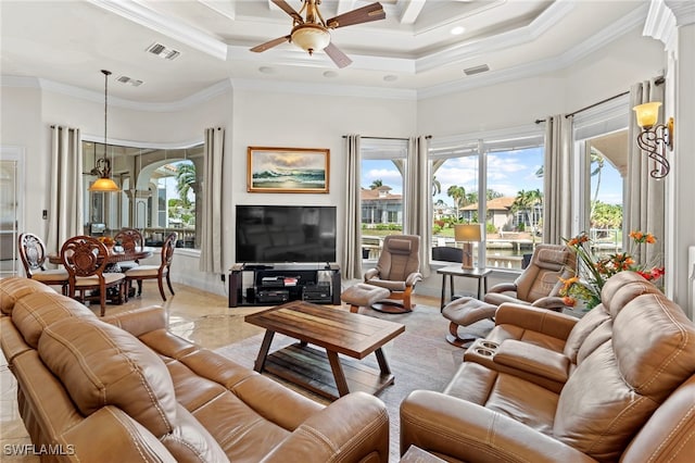 living room with ornamental molding, ceiling fan, a high ceiling, and a tray ceiling