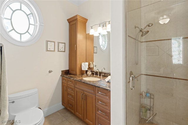 bathroom featuring plenty of natural light, vanity, tile patterned flooring, and a shower with shower door