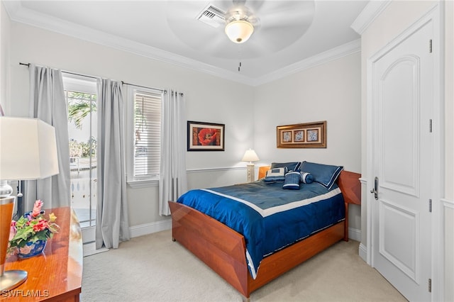 carpeted bedroom featuring ceiling fan and crown molding