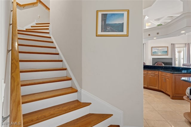 staircase featuring tile patterned flooring