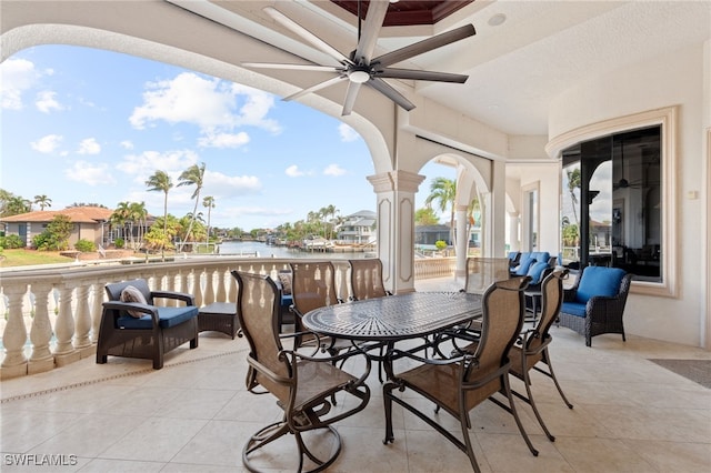 view of patio featuring a water view and ceiling fan