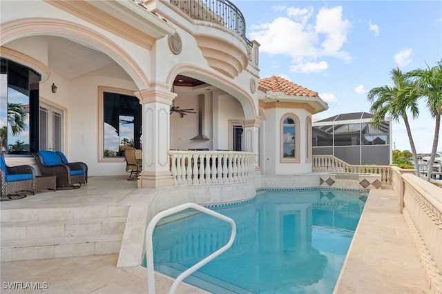 view of swimming pool with glass enclosure and a patio