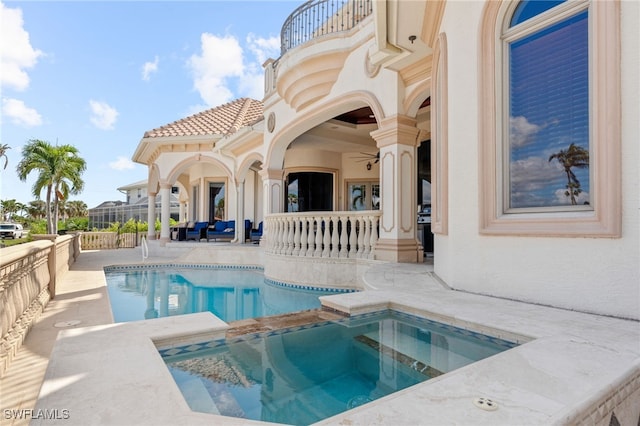 view of swimming pool featuring a patio and an in ground hot tub