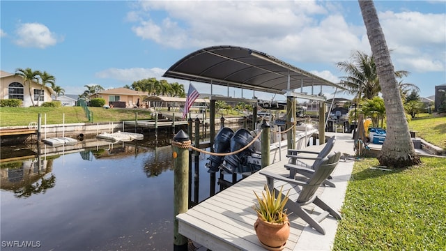 view of dock with a water view and a yard