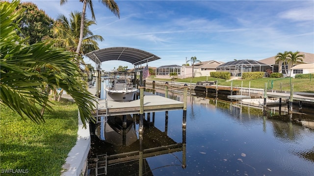 view of dock with a water view, a lawn, and a lanai