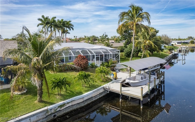 dock area featuring a yard, glass enclosure, and a water view