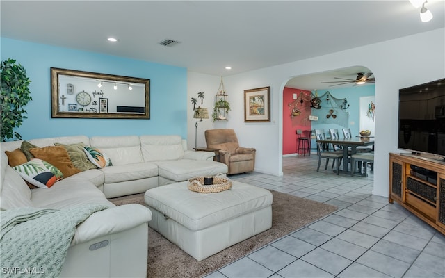 living room with ceiling fan and light tile patterned flooring