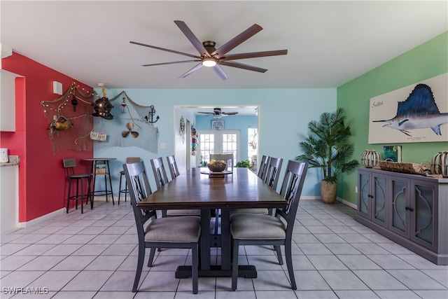 dining space featuring ceiling fan and light tile patterned flooring